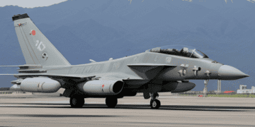 A fighter jet on a runway with a mountain in the background, representing the strength and advancement of Japan's defense capabilities.
