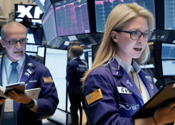 Two women standing on the floor of the New York Stock Exchange witness gains in global stock futures.