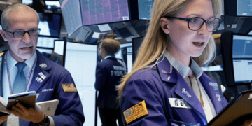 Two women standing on the floor of the New York Stock Exchange witness gains in global stock futures.