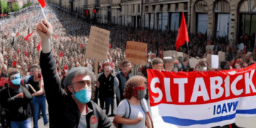 A group of people holding a sign during a protest on Labour Day.