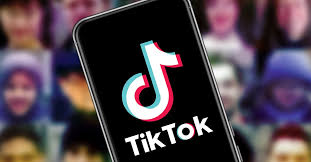 The TikTok logo is displayed on a smartphone during activism for environmental policy debates.