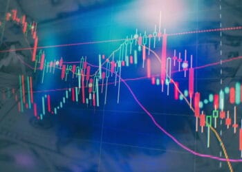 An Asian stock chart displaying a decline, with money notes subtly laid out in the background.