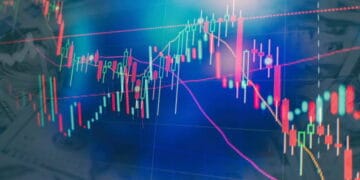 An Asian stock chart displaying a decline, with money notes subtly laid out in the background.