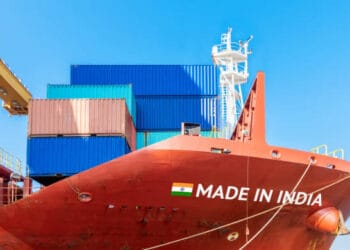 A container ship proudly displaying the words "Made in India" on its side, emphasizing India's export performance.