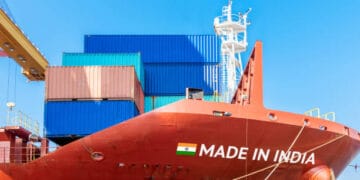 A container ship proudly displaying the words "Made in India" on its side, emphasizing India's export performance.