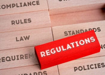 A red sign with the word regulations stacked on top of wooden blocks, highlighting the $13 Million Settlement.