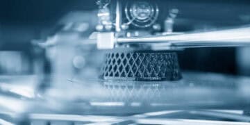 An advanced additive manufacturing process showcasing a close up of a 3D printer, exemplifying GKN Aerospace's commitment to sustainability.