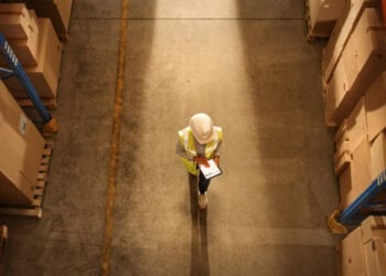 A worker in a warehouse utilizing Locus Robotics.