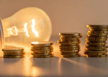 Stacks of coins next to a light bulb with Chinese Imports