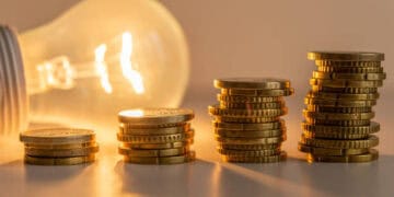 Stacks of coins next to a light bulb with Chinese Imports
