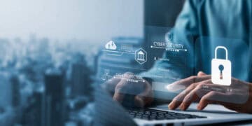 A man using a laptop to access a secure online banking platform, ensuring protection against potential imposter scams.