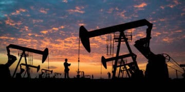 Silhouetted oil pumps at sunset; OPEC+ geopolitical tensions. - Supply Chain News