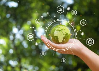 A hand holding a green earth with icons connected to it, symbolizing Brazil's Ratification of the South-South Trade Agreement and its subsequent Activation.