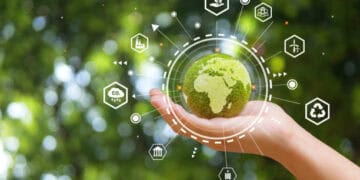 A hand holding a green earth with icons connected to it, symbolizing Brazil's Ratification of the South-South Trade Agreement and its subsequent Activation.