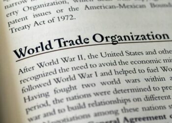 An open book with the word world trade organization prominently displayed on its pages.
