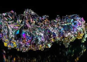 A colorful piece of rock on a black background sourced globally.