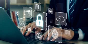 A businessman using a laptop with SentinelOne security icons on it.