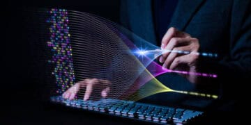 A man in a suit is using a computer keyboard to contribute to the 17th Annual State of Agile Report.