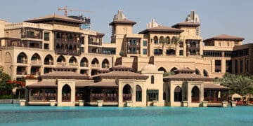 The Palm Dubai Resort, known for its CSR activities, offers a luxurious stay with a large pool in front of it.