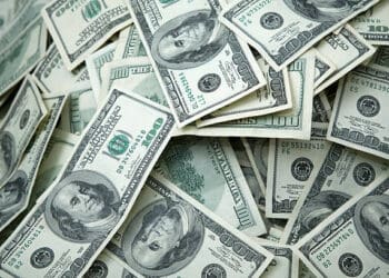 A pile of dollar bills, representing economic data and attracting investors.