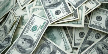 A pile of dollar bills, representing economic data and attracting investors.