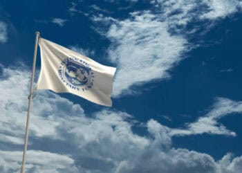 China's Recovery - A flag waving in the wind against a cloudy sky, heralding IMF's positive outlook on Asia's Economic Forecast.