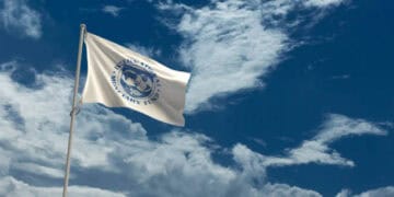 China's Recovery - A flag waving in the wind against a cloudy sky, heralding IMF's positive outlook on Asia's Economic Forecast.