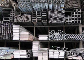Various steel pipes and tubes are stacked in a warehouse, highlighting the impact of UK's WTO steel import tariffs.