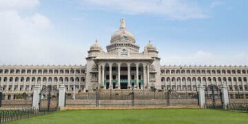 An ornate building with Quality Control Measures in front of it.