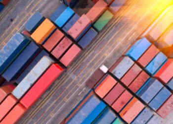 An aerial view of containers in a container yard located in the Red Sea, highlighting the connection between global trade and potential supply chain disruptions.