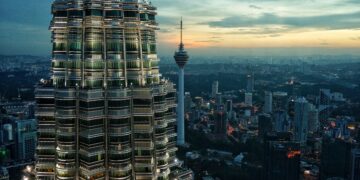 Kuala Lumpur skyline at sunset, featuring Petronas Towers and KL Tower. - Supply Chain News