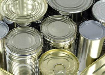 A group of tin cans on a white background, representing the impact of tariffs on U.S. tin mill steel imports.