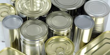 A group of tin cans on a white background, representing the impact of tariffs on U.S. tin mill steel imports.
