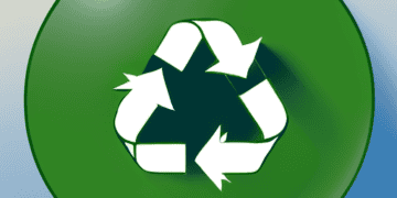 A green button with a recycling symbol on it, designed to raise awareness amongst fashion industry executives about reducing plastic packaging use.