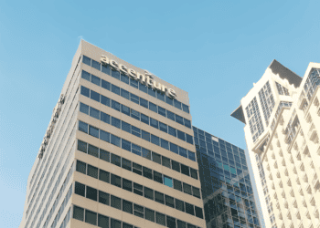 A large building expands into the blue sky in the background.