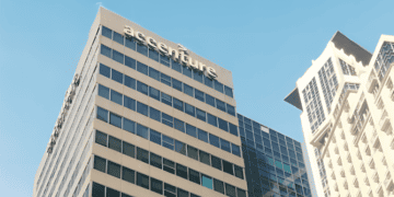 A large building expands into the blue sky in the background.