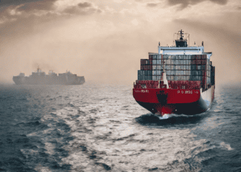 Container ship sailing on a choppy sea, illustrating global freight challenges. - Supply Chain News