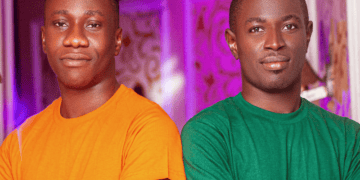 Two Shoptreo founders in orange and green t-shirts. Shoptreo.com logo visible. - Supply Chain News