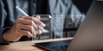 Person using a stylus on a laptop, reviewing digital checklists and documents related to East African flower exports and UK trade agreements. - Supply Chain News