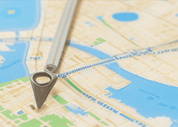 Map with a compass pointing to a location, illustrating geocoding for enhanced risk management in insurance. - Supply Chain News