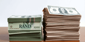 Stacks of US dollar bills and South African Rand banknotes. Trade uncertainty. - Supply Chain News