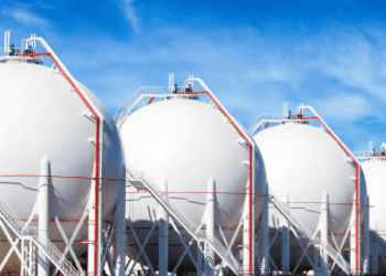 Row of large LNG storage tanks. Europe's declining gas demand impacts LNG imports. - Supply Chain News