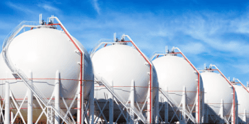 Row of large LNG storage tanks. Europe's declining gas demand impacts LNG imports. - Supply Chain News
