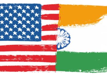 US and India flags merged, symbolizing trade relations. Tariffs on Indian goods. - Supply Chain News