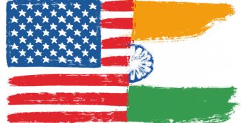 US and India flags merged, symbolizing trade relations. Tariffs on Indian goods. - Supply Chain News