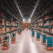Warehouse interior with rows of boxes and autonomous robots, potentially impacted by US tariffs on imported goods. - Supply Chain News