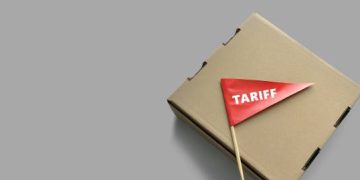 Cardboard box with a red "Tariff" flag, potentially representing new trade tariffs. - Supply Chain News