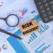 Risk Management concept with charts, calculator, magnifying glass, and pen - Supply Chain News
